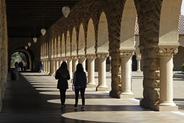 In this March 14, 2019, file photo students walk on the Stanford University campus in Santa Clara, Calif.  Paying off student debt is a key benefit that employers can use to attract workers.  (AP Photo/Ben Margot, File)