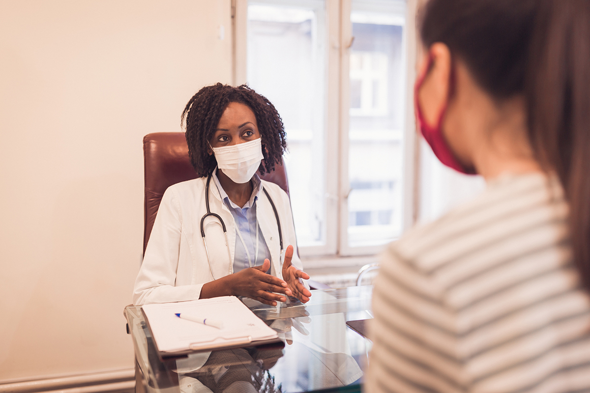 A doctor talks to her patient