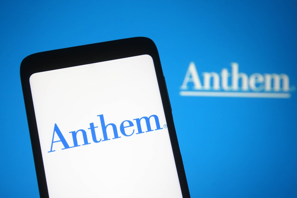 In this photo illustration the Anthem logo of a US insurance company is seen on a smartphone and a pc screen.