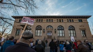 Rich Shannon holds up a sign alongside other supporters who gathered for a "Health For All Universal Health Coverage Day" rally in support of Sen. Bernie Sanders' Medicare for All Bill at the Oak Street Plaza in Fort Collins in December 2017.