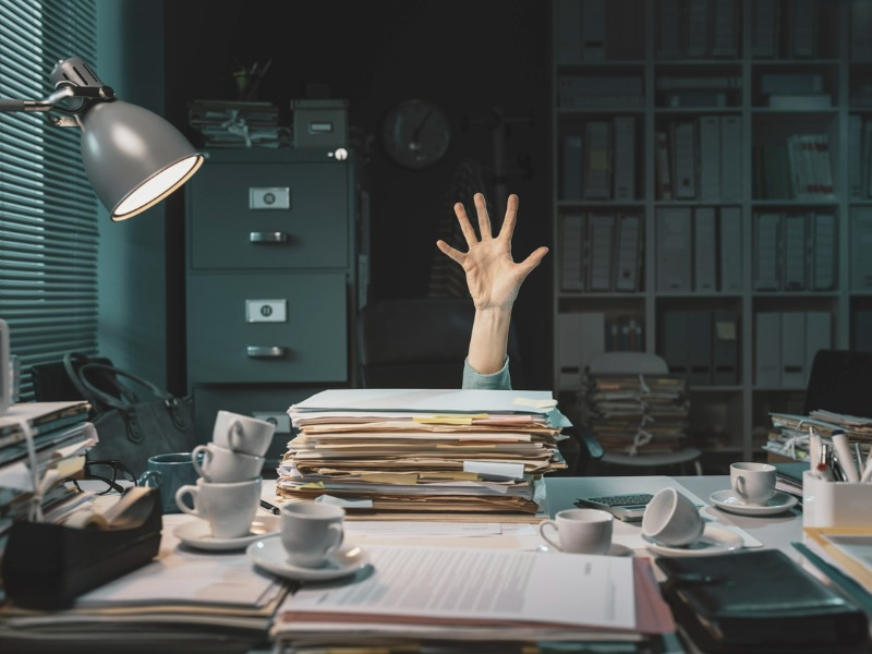 Person drowning in paperwork.