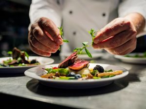 Chef preparing pan-fried duck.