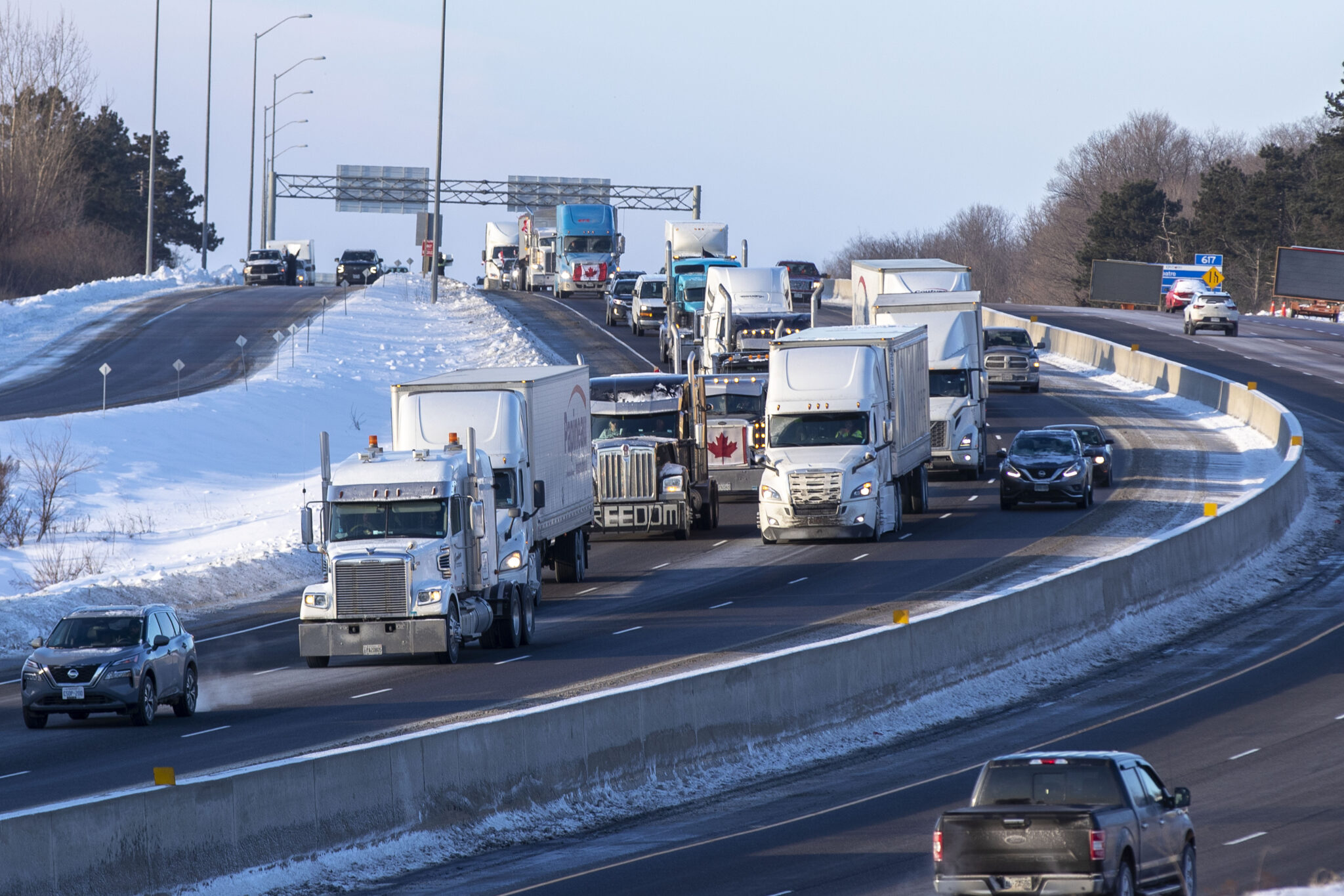 Trucks from the “Freedom” convoy travel on Highway 401 headed eastbound in Kingston, Ont., headed for Ottawa, on Friday Jan. 28, 2022. THE CANADIAN PRESS/Lars Hagberg