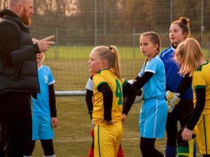 Soccer dad coaching daughter's team