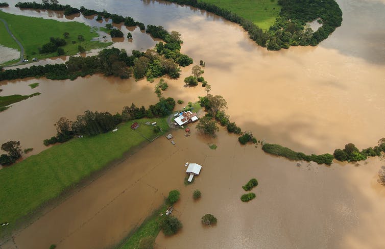 farmhouse and fields submerged by floodwaters