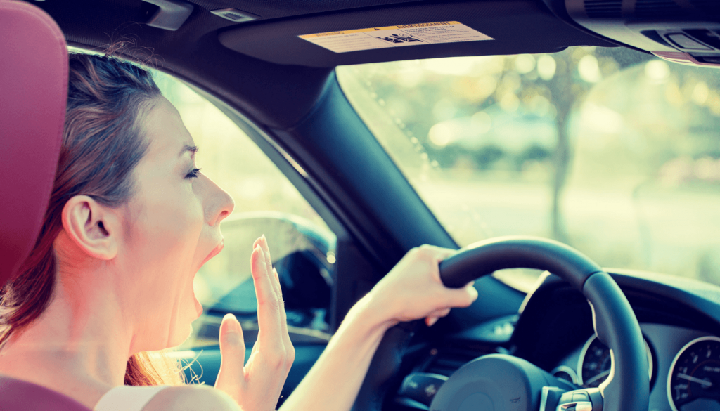 Women yawing in car because she has sleep apnea