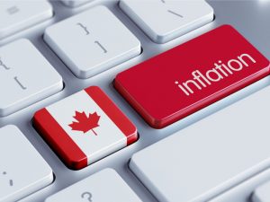 The word 'inflation' on a keyboard with a Canada flag