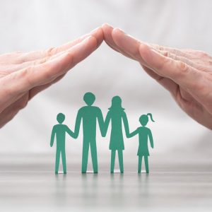 Hands protecting a family