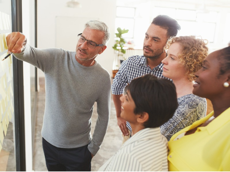 Diverse group of people brainstorming at a casual office.