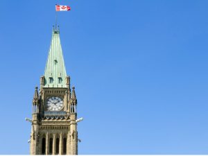 Peace tower in Ottawa with Canadian flag.