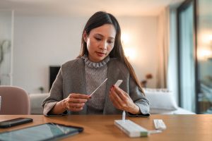 Woman Holding Covid Rapid Test And Waiting For Results