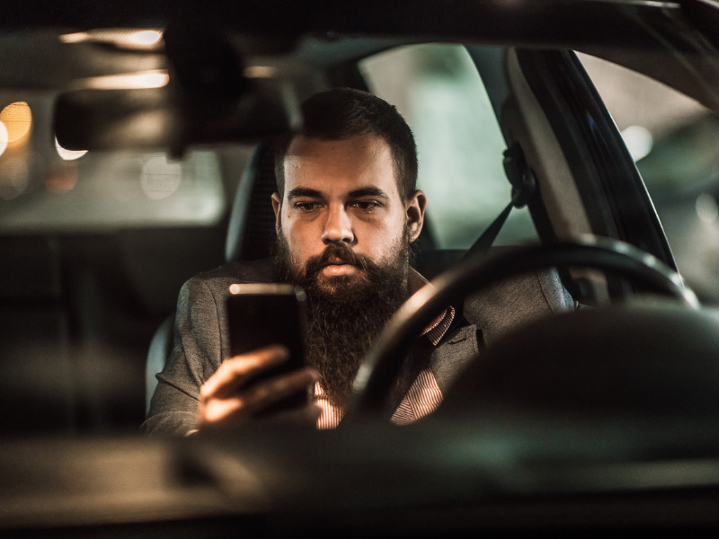 Man using cellphone while driving