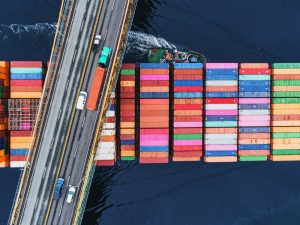 A container ship passes beneath a suspension bridge as it departs for Europe.