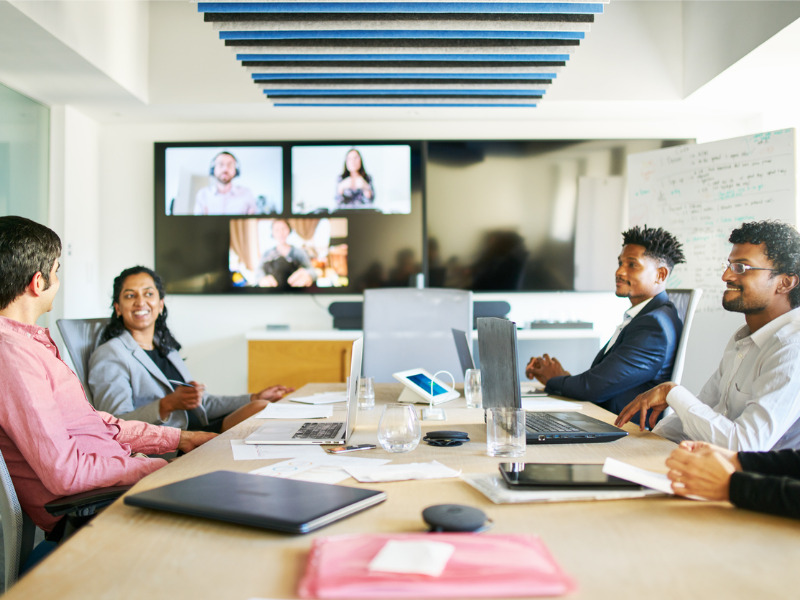 Smiling young businesspeople talking during a video conference call