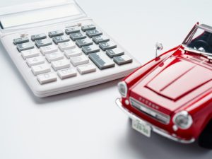 Calculator and sports car on a white background