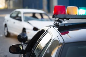 A police officer at a car accident scene.