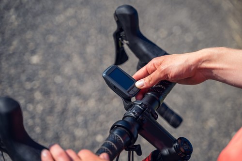 a cyclist using a navigation device attached to the handlebar of their bike