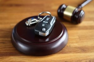 Gavel and remote control from car on table.