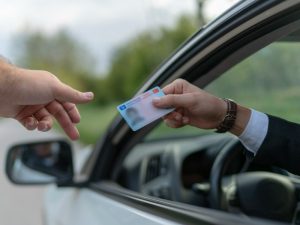 Driver handing over a license.