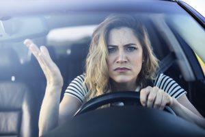 Angry woman driving a car.