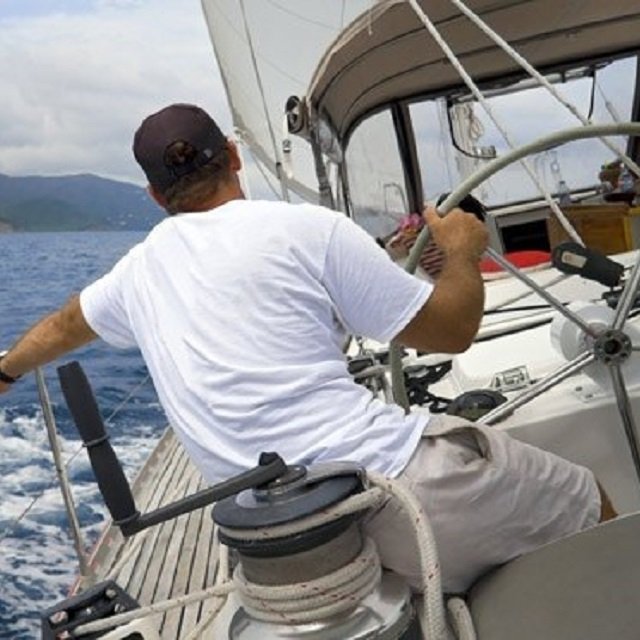 A man sailing a sailboat