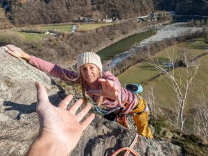 Rock climber getting a helping hand.