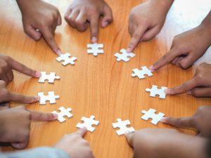 Group of business people assembling a jigsaw puzzle