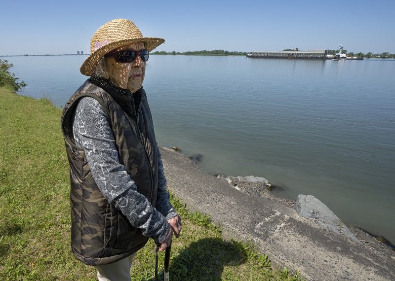 Angelique Beauchemin, 100, looks at erosion on her property on the shore of the St. Lawrence River