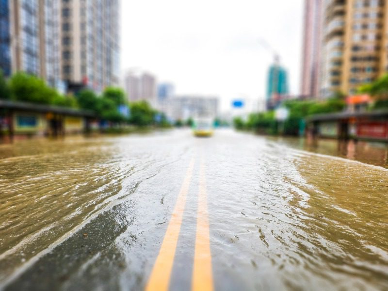 Streets inundated by heavy rain in the city. The background of urban construction and management.