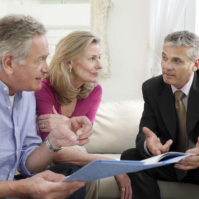 A couple sitting with an advisor