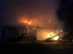 Firefighter trying to put out a house on fire