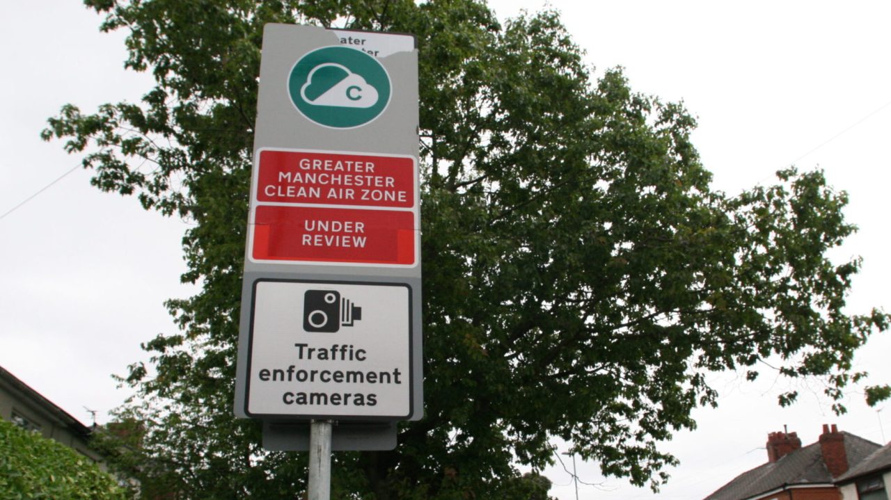 Sign showing Manchester Clean Air Zone under review