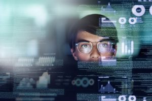 Cropped shot of a young computer programmer looking through data