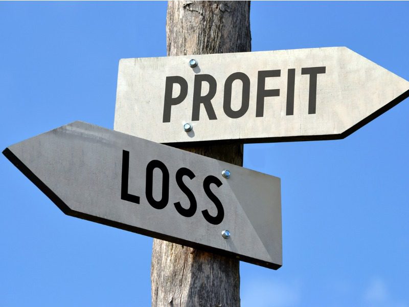 Arrows pointing to profit and loss as if it was a road sign.