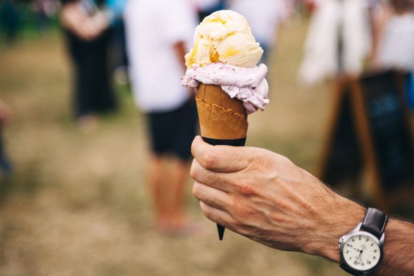 Person holding ice cream at festival