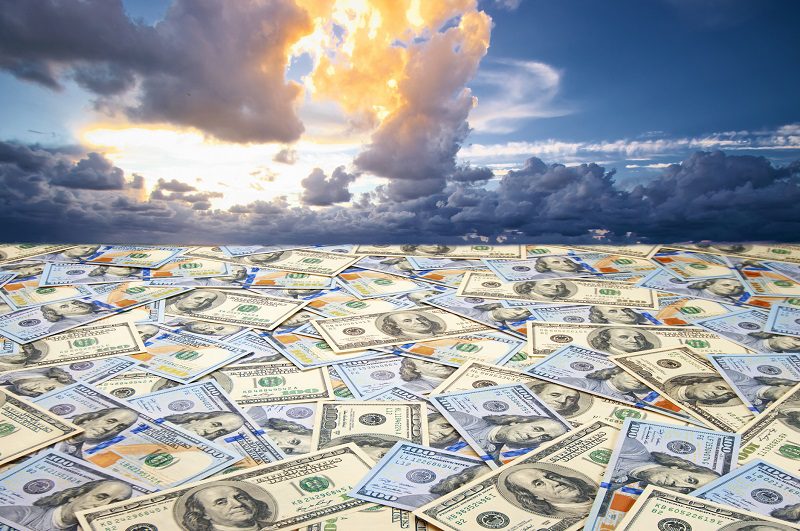 Conceptual abstract landscape: sea of money and dramatic sky.