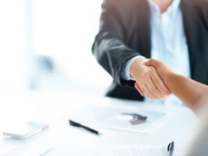 Two businesswomen shaking hands to seal the deal