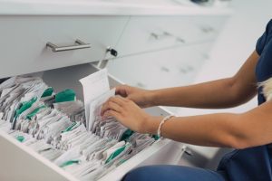 Close up of woman hands, arranging patient files