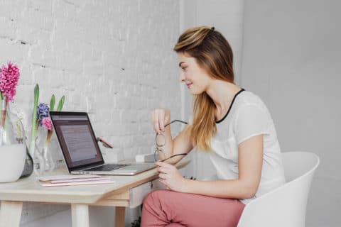 Woman sitting at her desk doing research on the computer