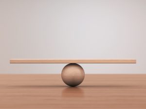 A beam balancing on a ball, symbolizing equilibrium