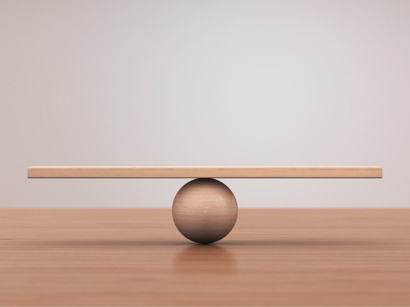 A beam balancing on a ball, symbolizing equilibrium
