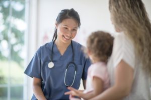 Nurse Speaking to a Mother and Child