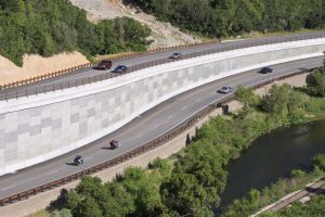 Multi-level highway through a mountain canyon.