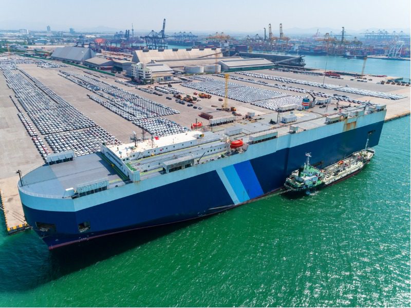 Roll-on, roll-off car carrier loading at a port