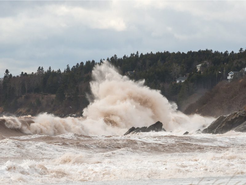 Big wave breaking on rocks following hurricane