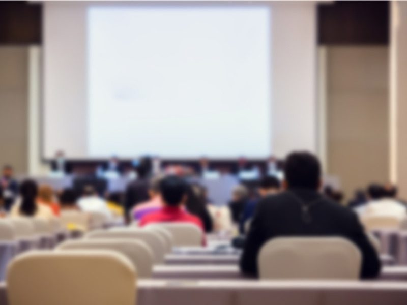 Shareholder meeting in an auditorium