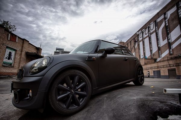 Black modified Mini Cooper on an overcast day