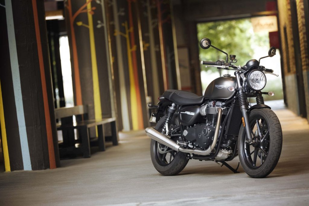 Triumph Street Twin parked inside industrial looking building