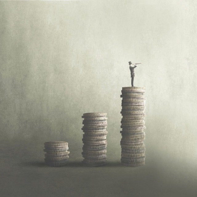 Man standing on stack of coins with telescope