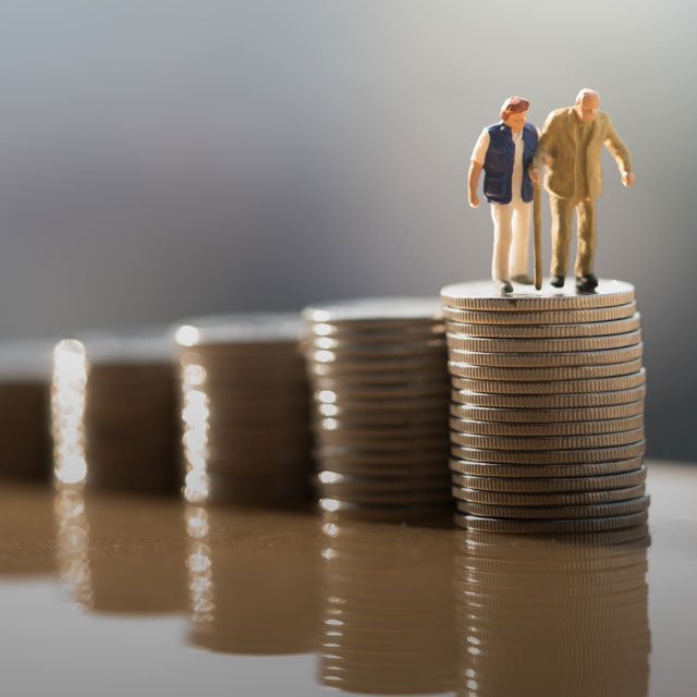 A couple climbs up stairs made of coins.